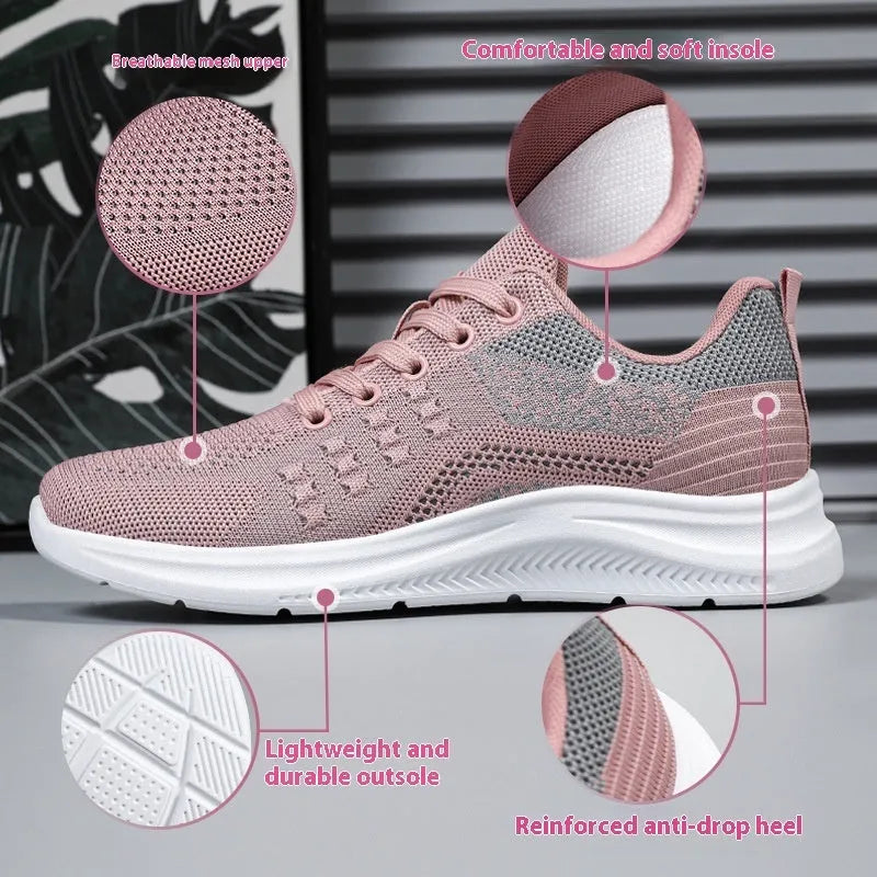 Women's low-top black mesh sneakers with white laces and a round toe on a grey background.