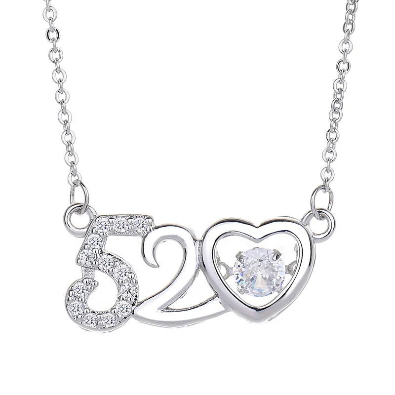 Silver heart necklace with crown and bow details on pendant, adjustable chain