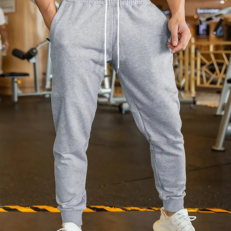 Men's loose-fit linen-style leisure trousers with an elastic drawstring waistband, shown in a neutral colour.
