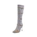 Grey and black women's knee high boots with a thin high heel on a rubber sole.