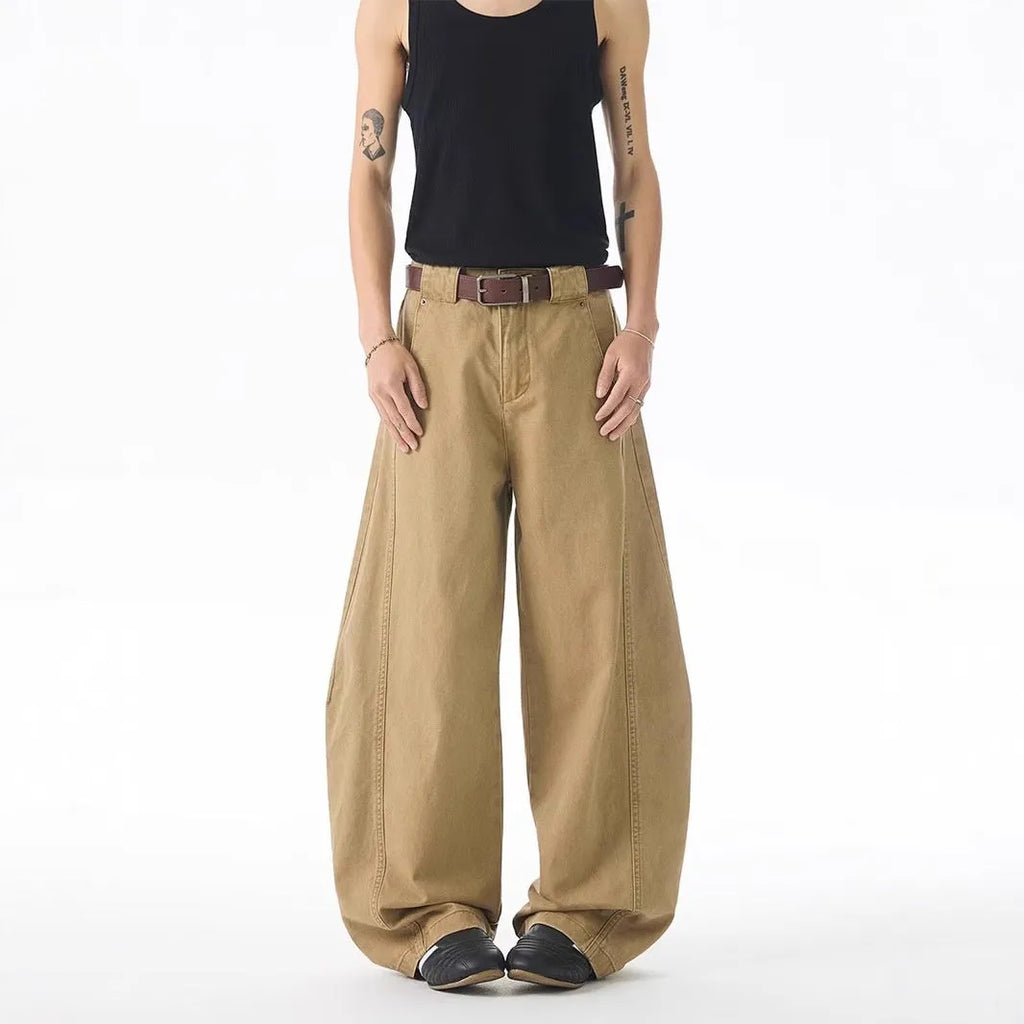 Brown men's straight-leg denim jeans with a loose fit and button fly on a neutral background.