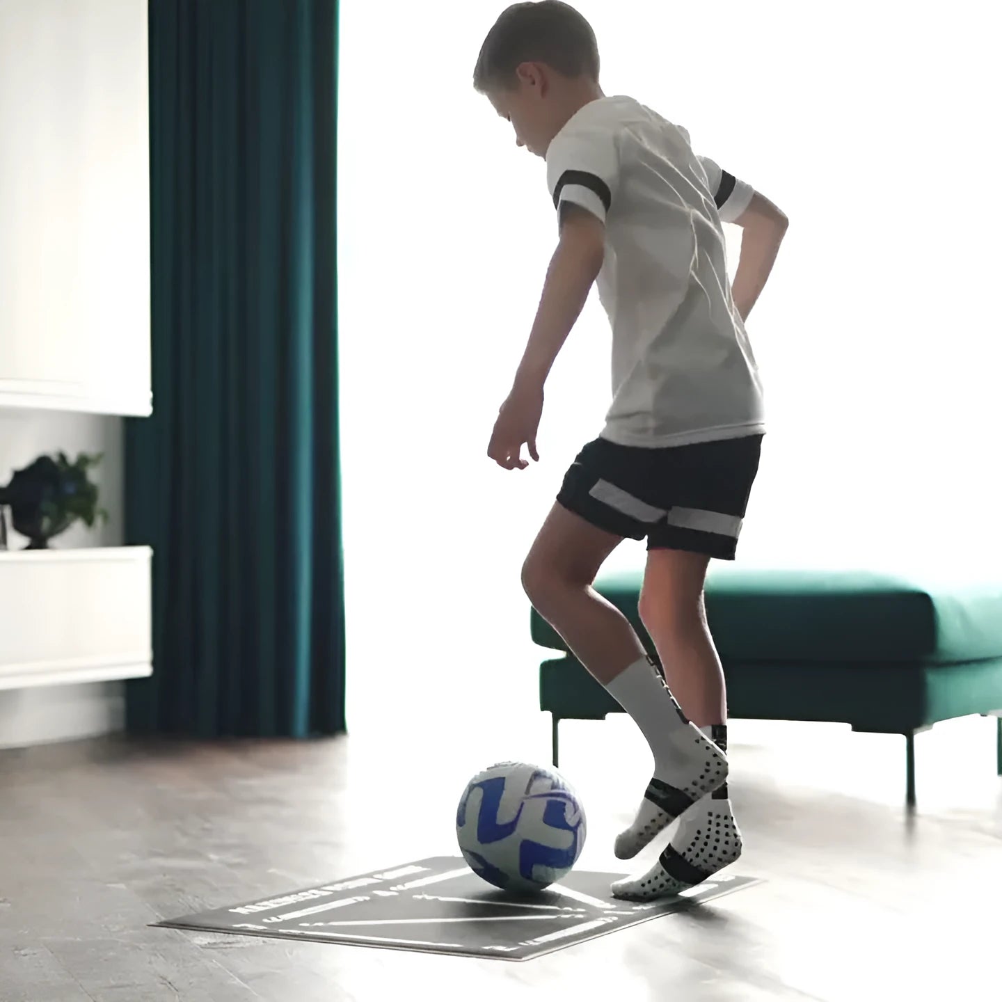 Black rectangular football training mat measuring 60cm by 90cm with non-slip surface