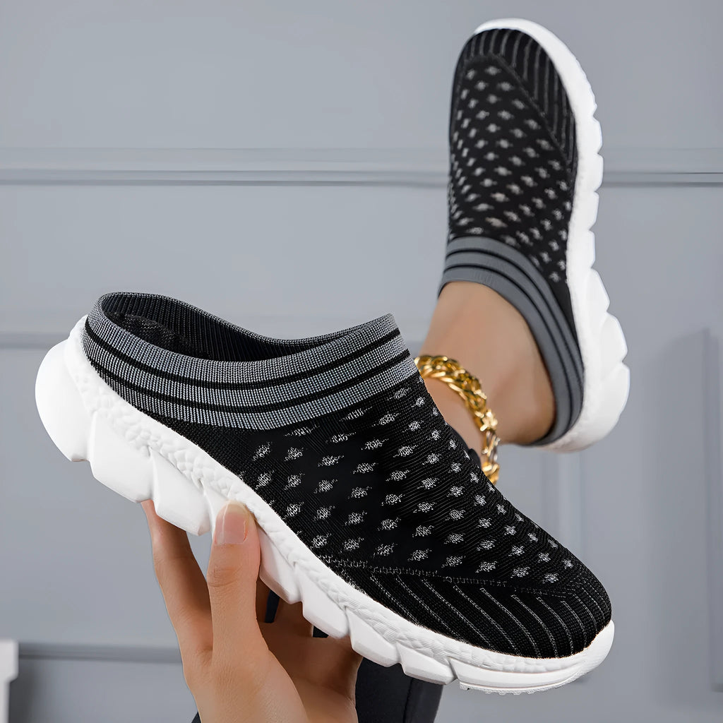 Women's black flyknit slippers with hollowed-out pattern and a height-increasing viscose sole.