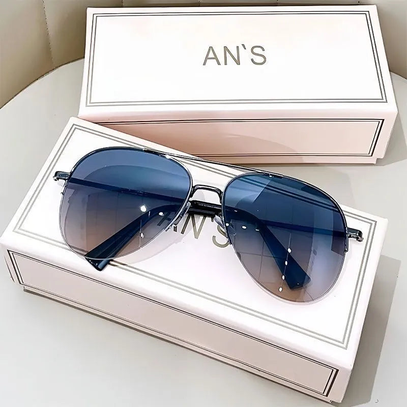 Gold frame aviator-style metal driving sunglasses with resin lenses for UV protection.