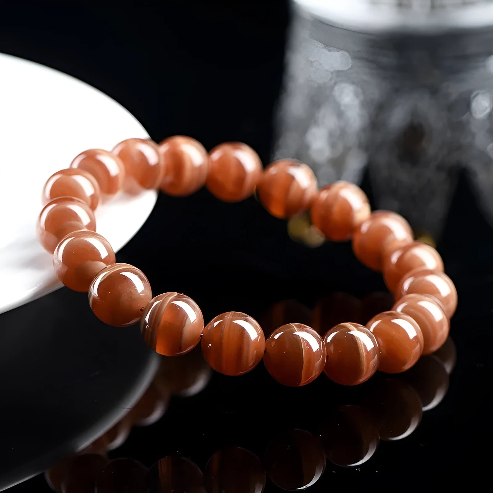 Natural Old Mine Rhodochrosite round bead bracelet from Peru showing pinkish-red mineral colour