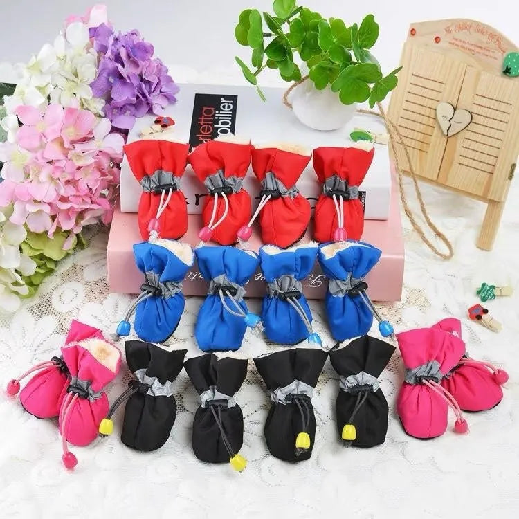 Set of four cloth dog shoes in various colours including fleece-lined red and monkey patterns