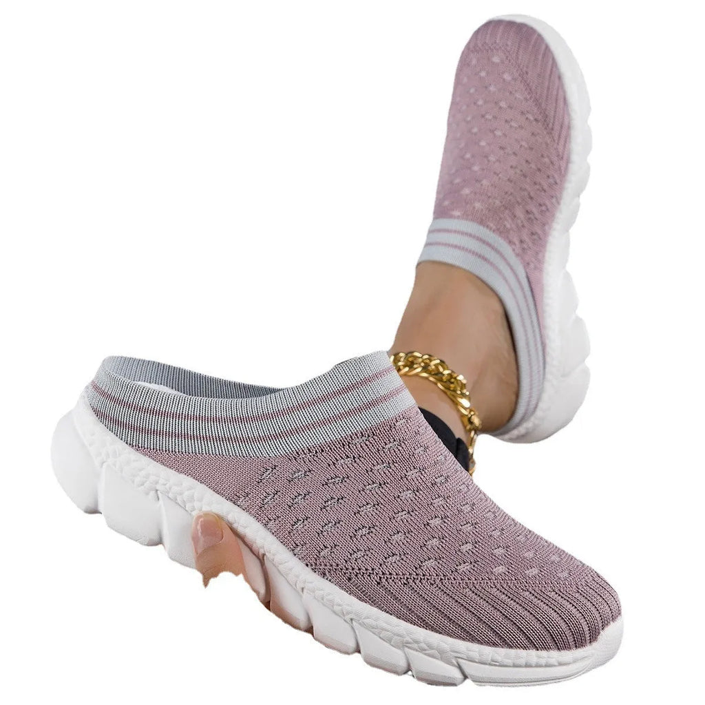 Women's black flyknit slippers with hollowed-out pattern and a height-increasing viscose sole.