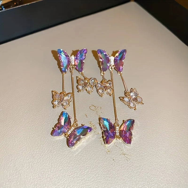 Silver needle blue purple butterfly tassel drop earrings with crystal flower details on alloy.