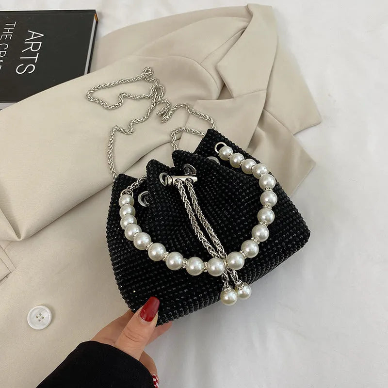 Women's fashion crossbody bag with diamond detailing and chain strap in soft PU material.