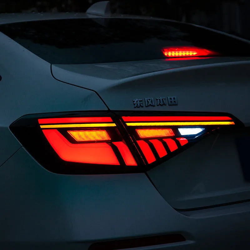 11th Generation Honda Civic black and red LED taillight assembly with sequential turn signals.