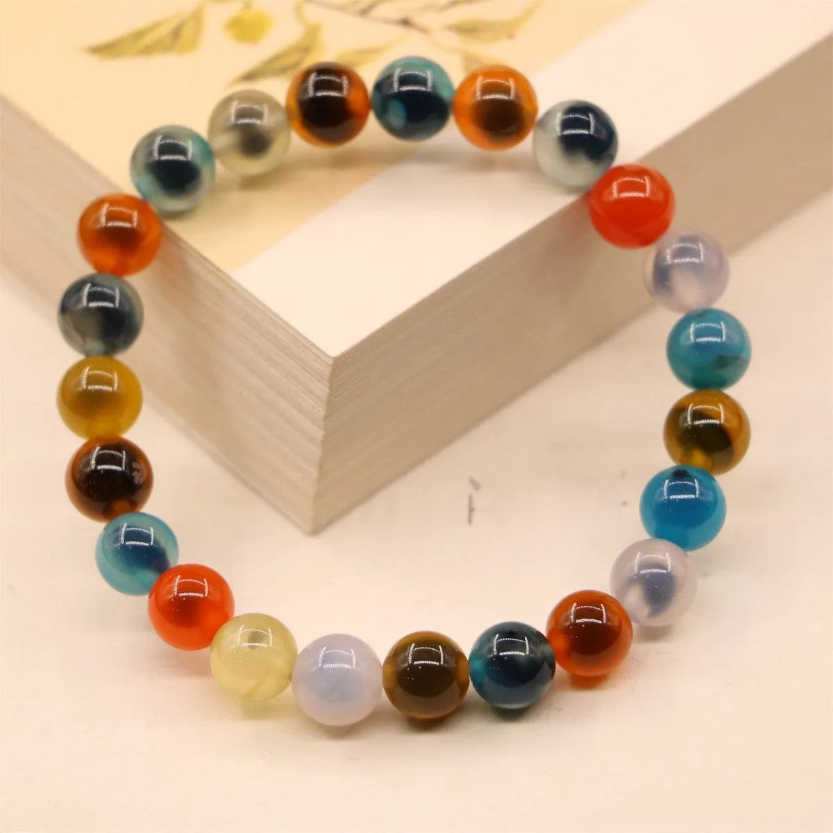 Women's agate snake bracelet with copper coin detailing and coloured glaze accents in geometric design