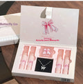 Butterfly coloured makeup box with four pink lip mud containers, blush compact, and necklace