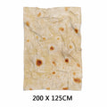 Round coral-coloured flannel burrito blanket with a delicious food print, folded to show soft texture.
