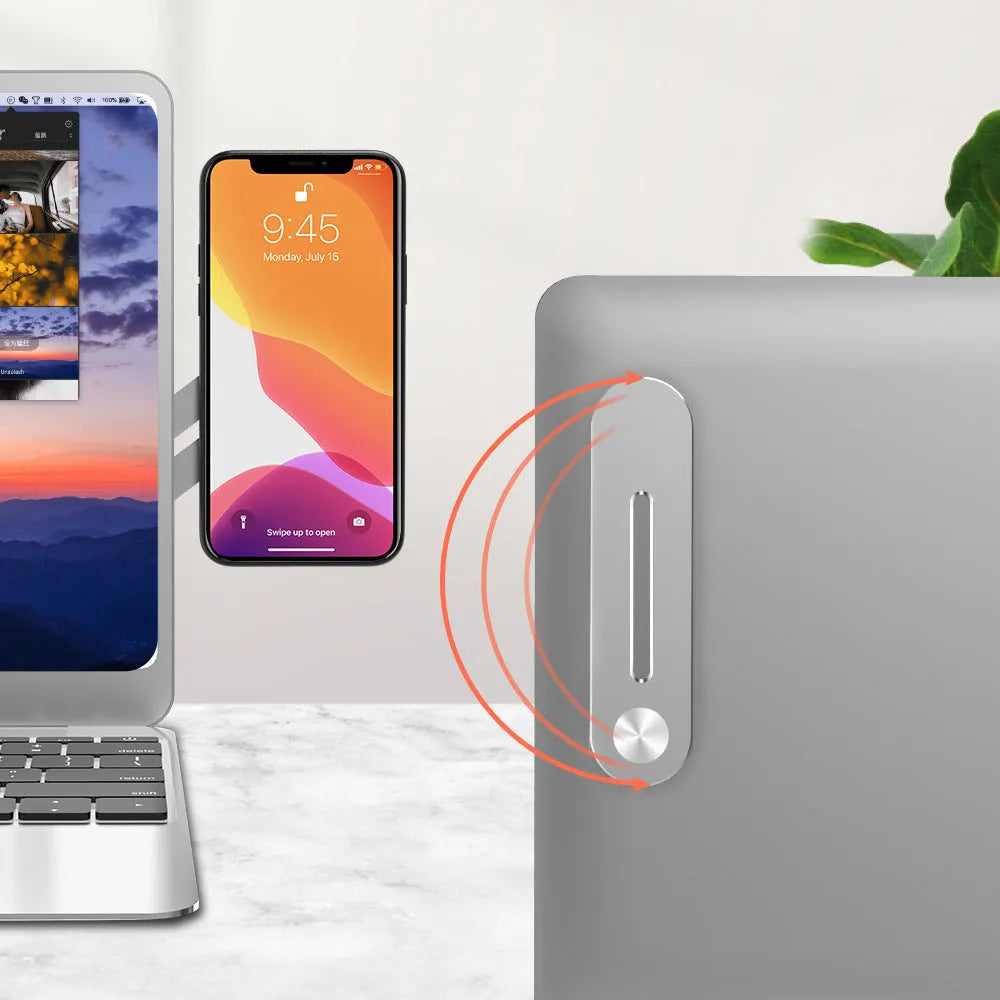 Aluminium laptop side mount bracket holding a smartphone next to a laptop, showing adjustable arm and magnetic pads.