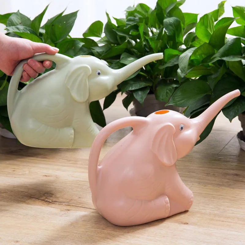 Blue plastic children's watering can shaped like a baby elephant with a long nozzle and bottle-style handle.