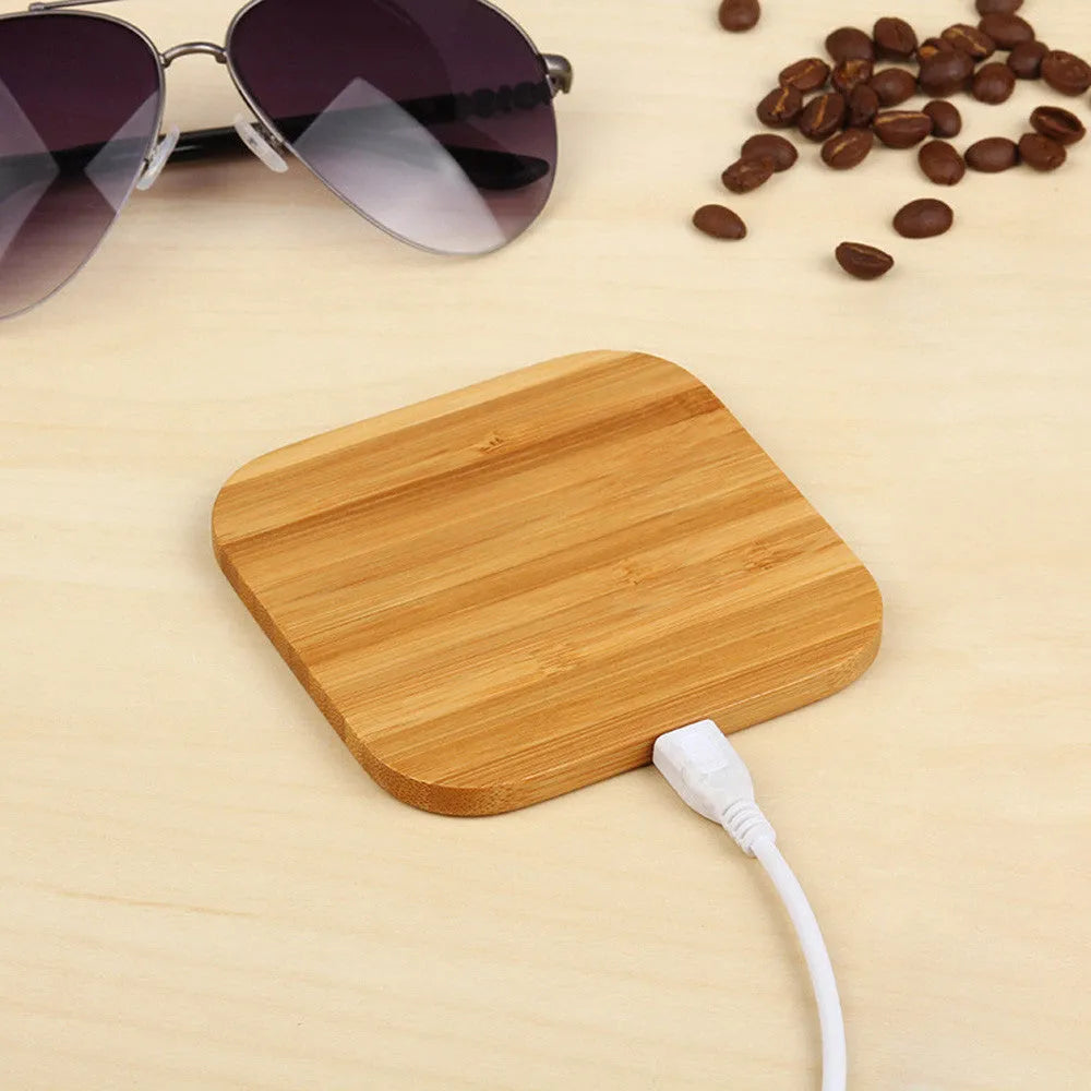 Square brown bamboo wood 5W wireless charger with green LED indicator on desk
