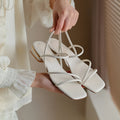Women's flat strap Roman sandals with square toe in microfiber, shown in beige colour.