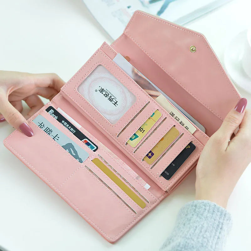 Women's black PU leather trifold wallet showing buckle closure and measuring 19.5cm