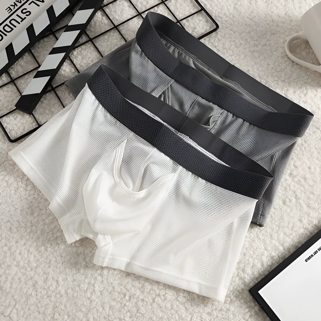 Men's ice silk mesh boxer briefs in black, white, and grey colours showing low waist design