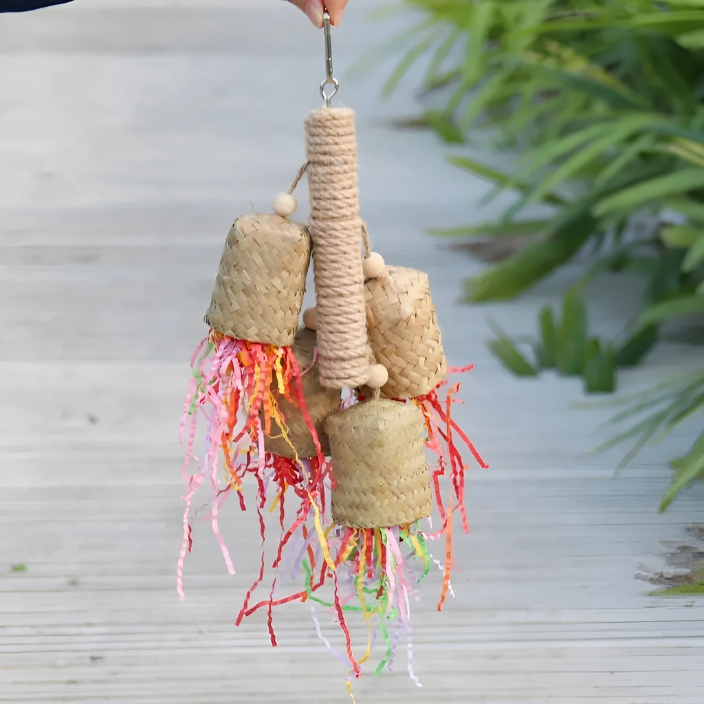 Colourful shredded paper parrot toy with wood and sisal construction measuring 15cm by 35cm