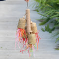 Colourful shredded paper parrot toy with wood and sisal construction measuring 15cm by 35cm