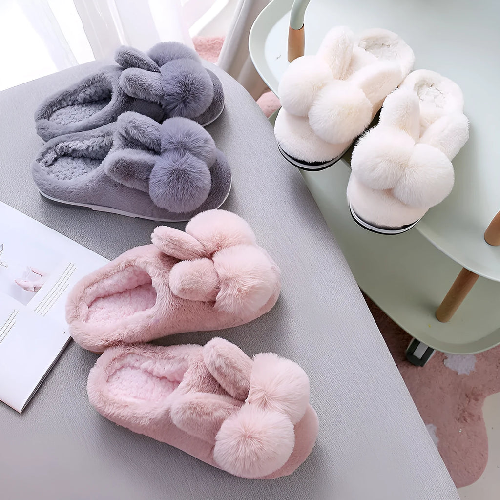 Women's fluffy bunny slippers in creamy white with a high rabbit fur upper and decorative flowers.