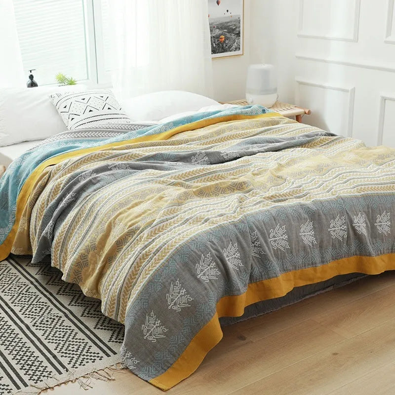 Blue five-layer gauze cotton bed sheet blanket folded, showing modern simplicity pattern and thickness.