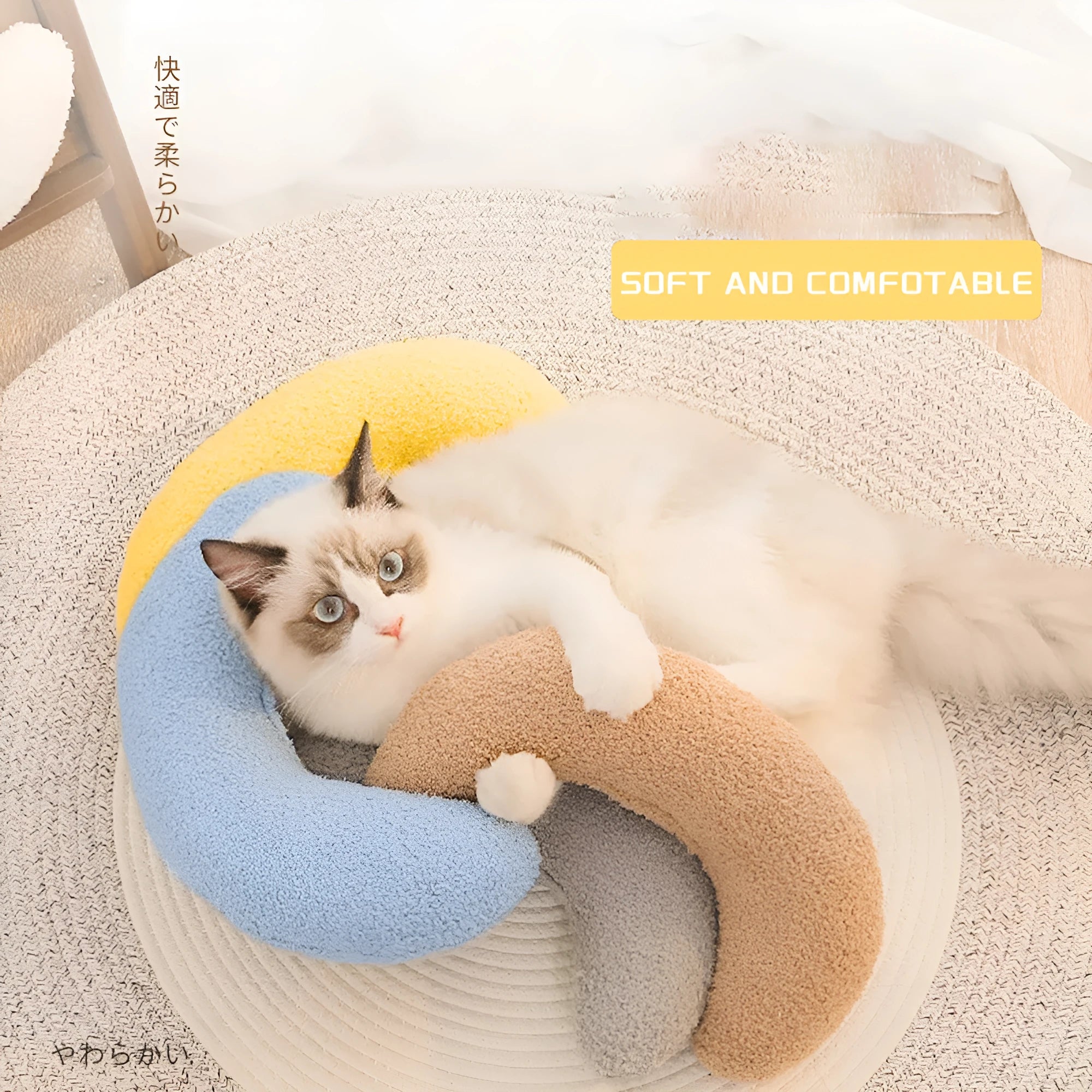U-shaped blue cat pillow with adjustable fabric collar on a sofa