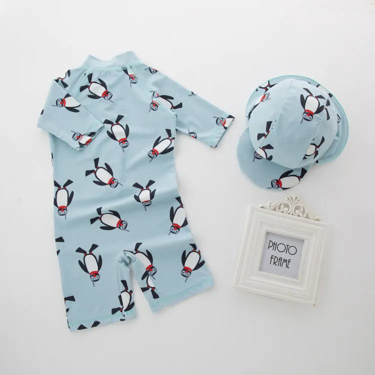 Boys' penguin print long sleeve swim shirt and matching swim cap set.