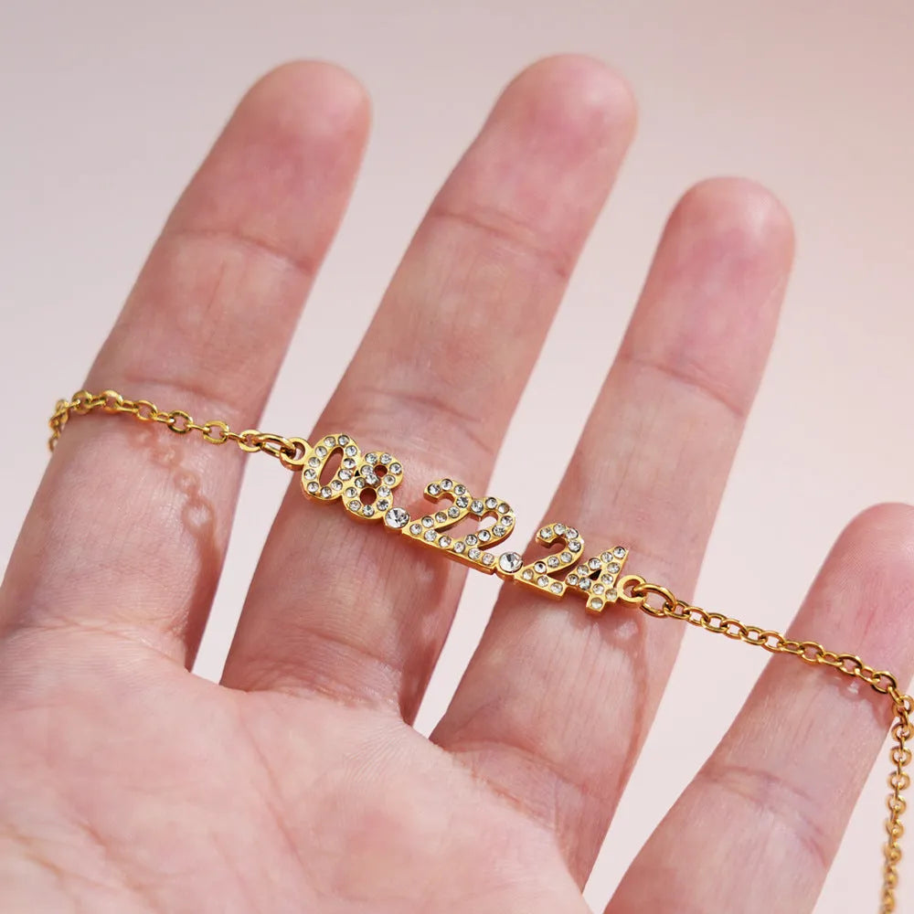 Stainless steel digital bracelet or necklace with diamond-set numbers in gold, rose gold, or steel colour.