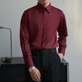 Man wearing a black loose-fit Korean style long sleeve cardigan shirt with Japanese retro design details.