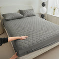 Diamond lattice quilted waterproof mattress protector set with fitted sheet and pillowcases in solid colour.