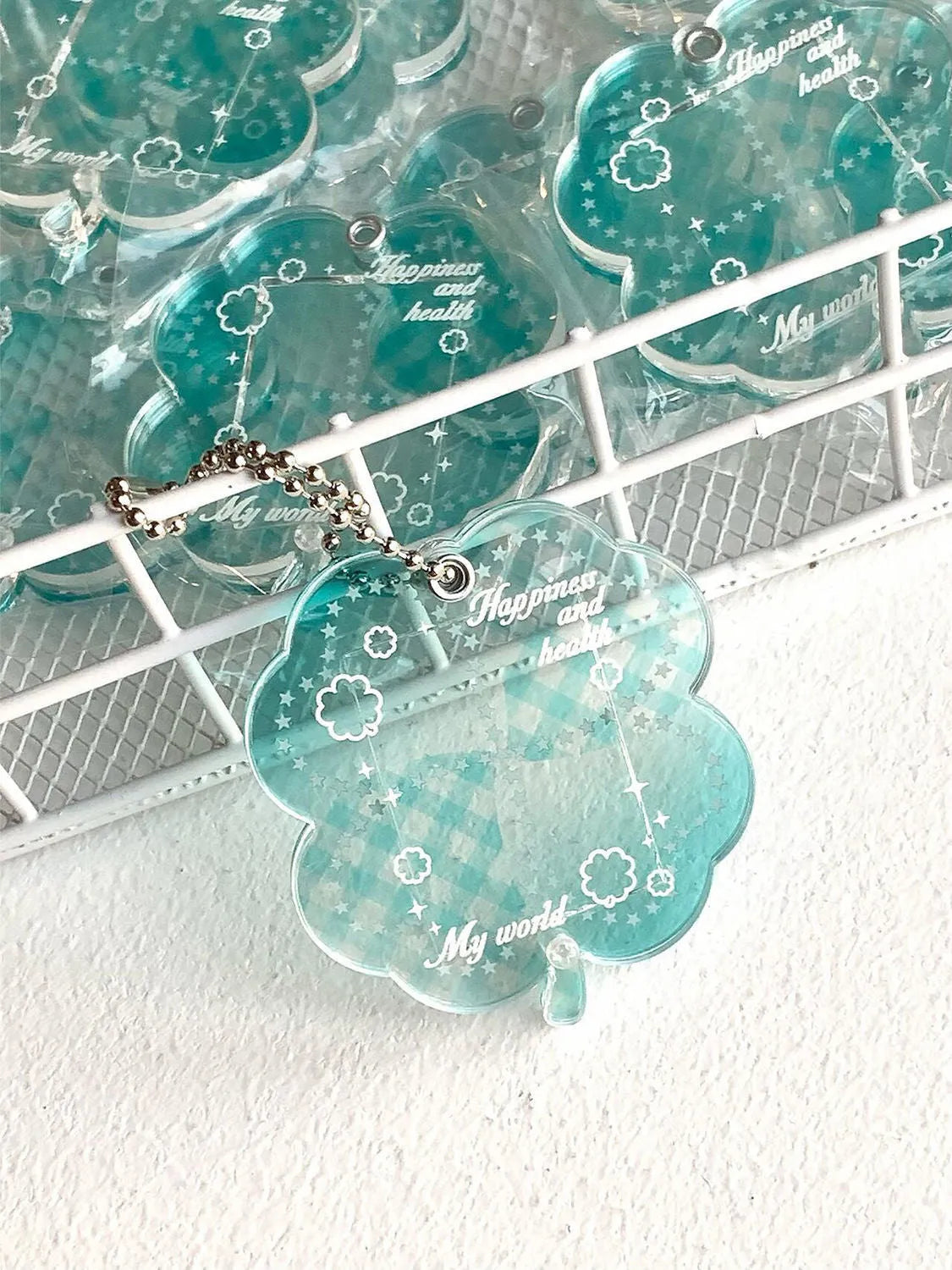 Acrylic four-leaf clover shape mobile phone pendant keychain in blue or green.