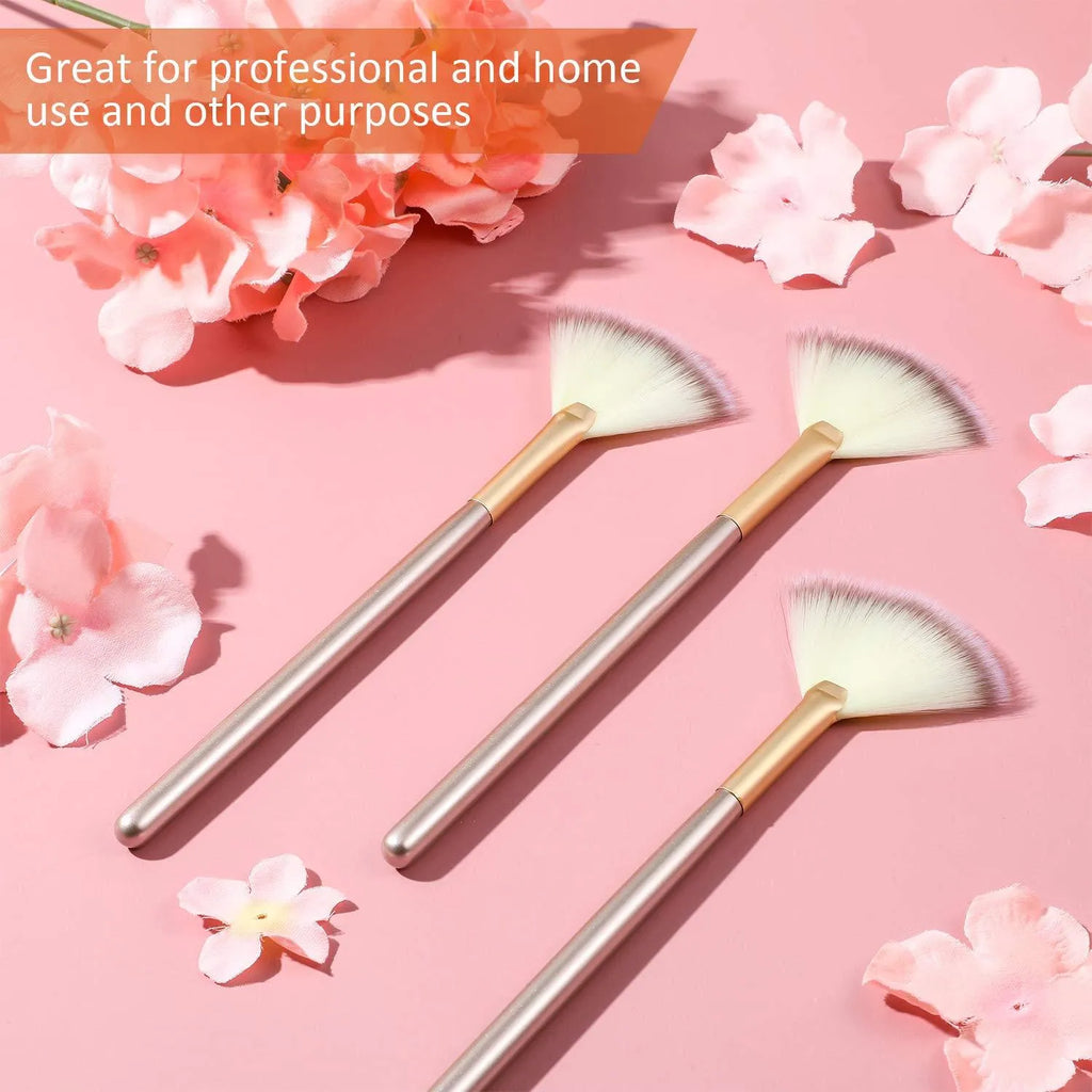 Ten champagne-coloured facial fan brushes with soft bristles and protective covers laid out.