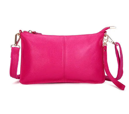 Lady's cowhide slant bag with hand strap and long shoulder strap shown in multiple colours.