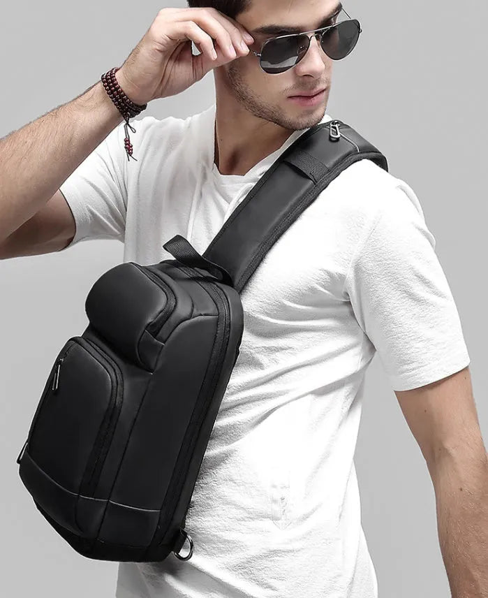 Black PVC outdoor leisure shoulder bag with air cushion strap showing organisational pockets