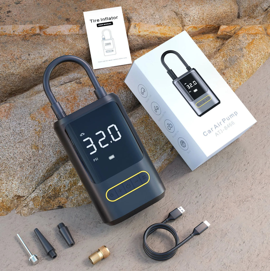 Handheld wireless digital display car air pump with LED light, hose, and multiple nozzles on black background