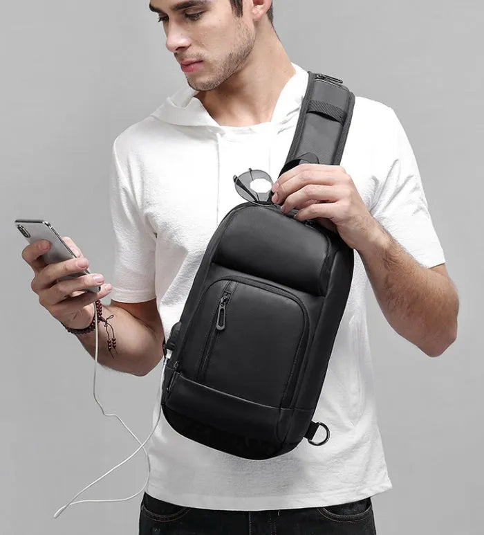 Black PVC outdoor leisure shoulder bag with air cushion strap showing organisational pockets