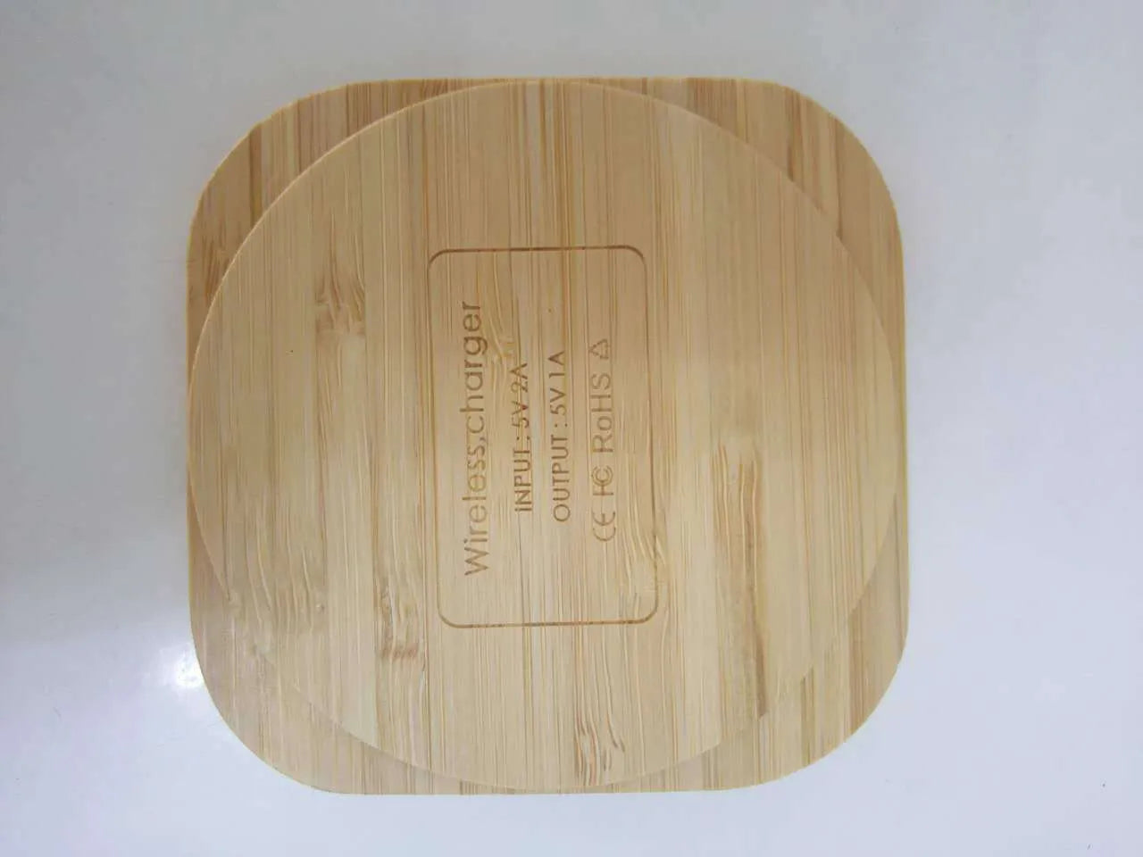 Square brown bamboo wood 5W wireless charger with green LED indicator on desk