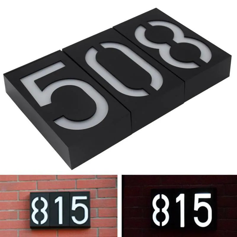 Solar-powered white LED house number light with IP65 waterproof rating mounted on an outdoor wall.