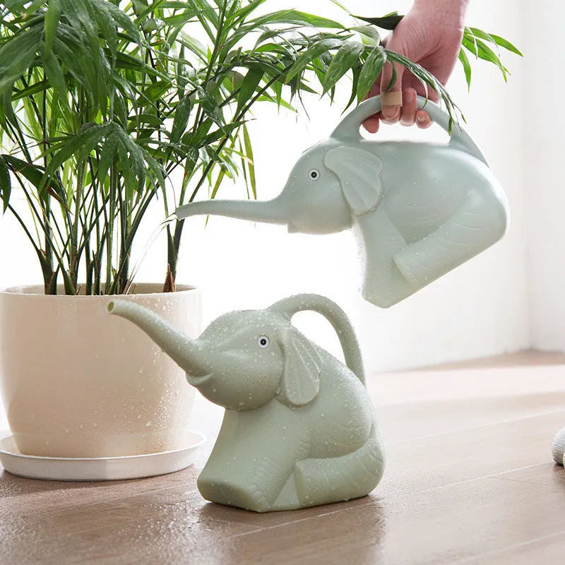 Blue plastic children's watering can shaped like a baby elephant with a long nozzle and bottle-style handle.