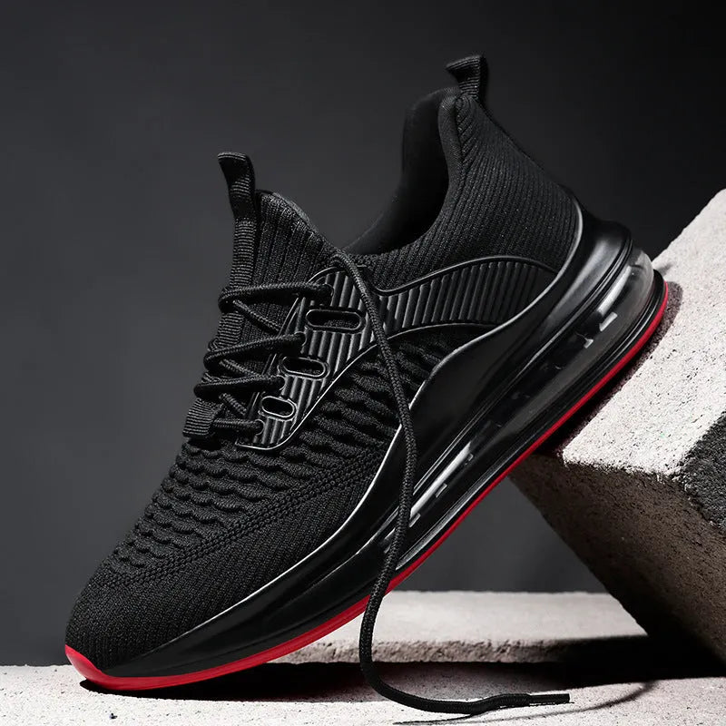 Men's low-top black mesh running sneakers with rubber sole and lace-up front, shown on a white background.