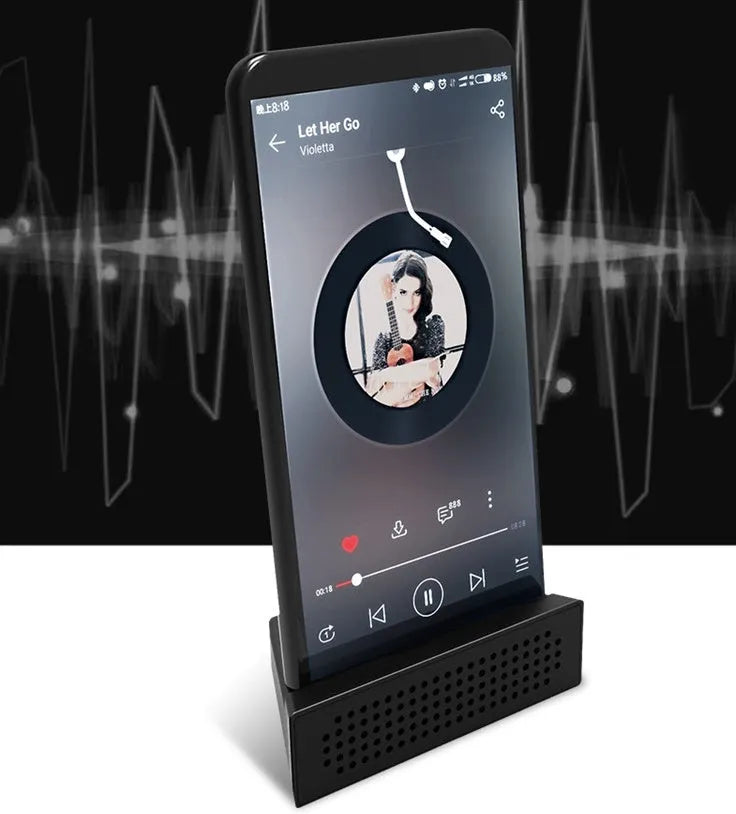 A portable black ABS mobile phone amplifier bracket holding an iPhone to boost sound for desktop use.