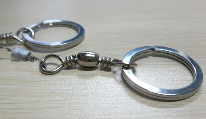 Stainless steel survival wire saw with thumb rings showing 55cm blade and pull ring assembly