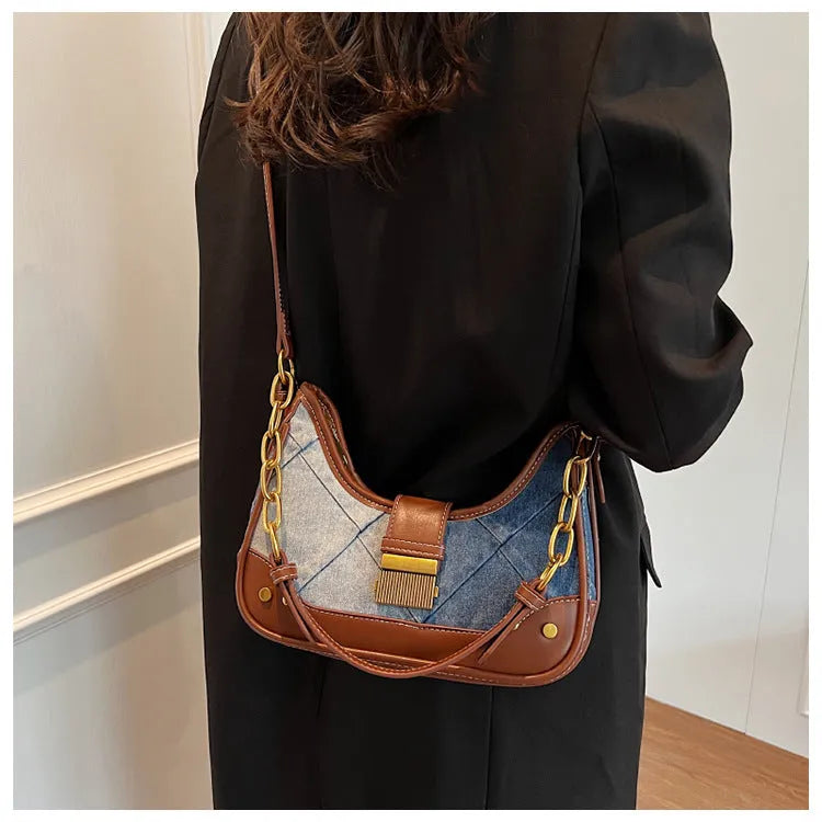 Brown denim women's bucket shoulder bag with chain strap and diamond mesh detail.