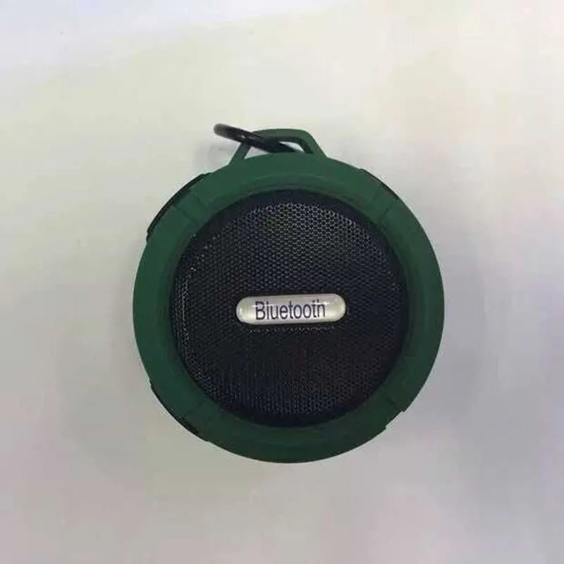 Colourful waterproof portable Bluetooth speaker with a black mounting buckle clip.