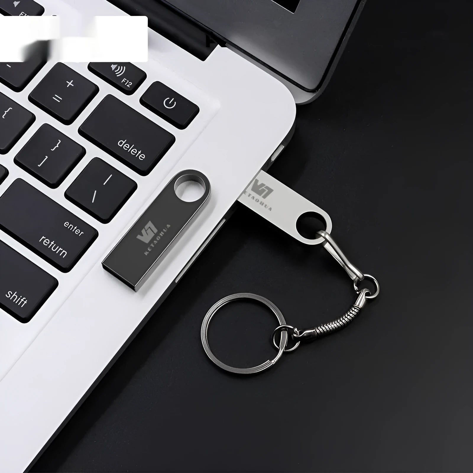 Slim silver metal USB flash drive on a dark background showing its compact 39mm length and 4.5mm thickness.