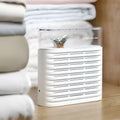 White reusable electric dehumidifier box with transparent leafy-design top and colour-change crystals.