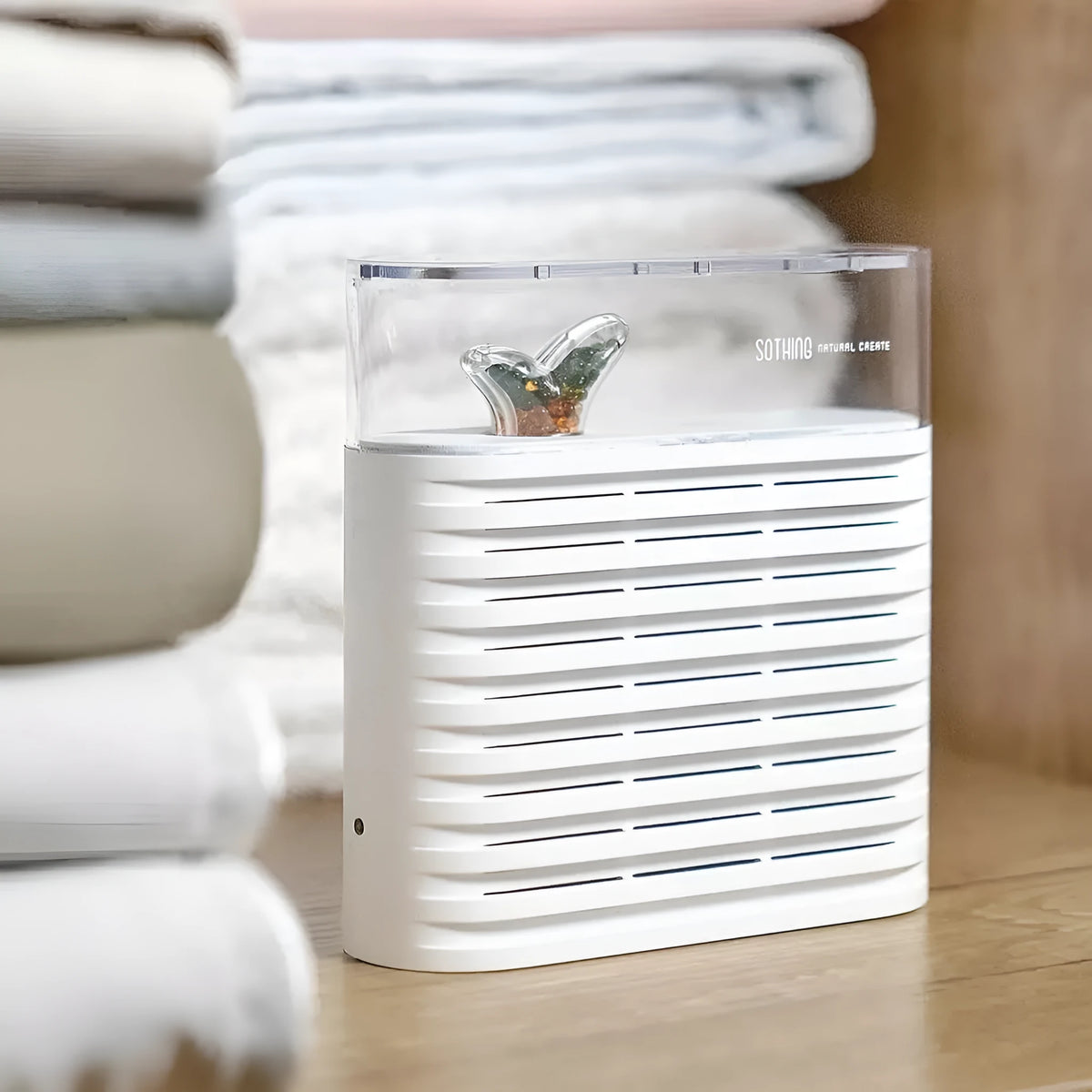 White reusable electric dehumidifier box with transparent leafy-design top and colour-change crystals.