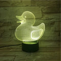 Little yellow duck 3D night light with remote control on a bedside table, showing colour change